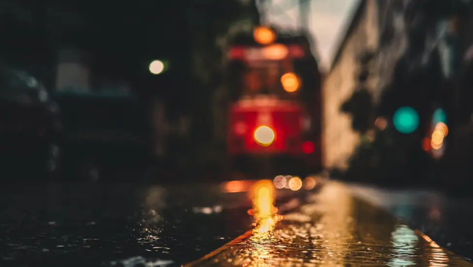 Blurry out of focus photograph of a trolley bus on a rainy day