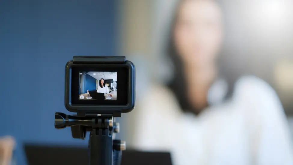tiny web camera recording a woman in the background