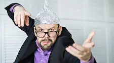 Man trying to communicate via thought while wearing a tin foil hat