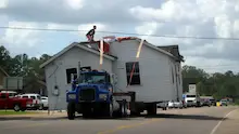 Moving a complete house on the back of a truck.