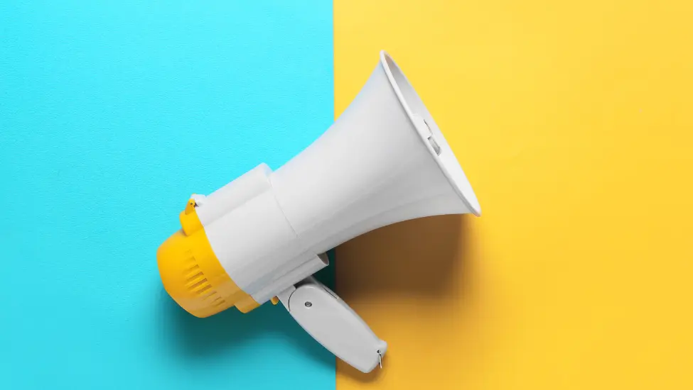 Hand help megaphone on a strong blue and yellow background