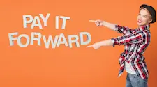 Woman in plaid lumberjack shirt pointing to the words pay it forward