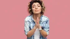 woman with hands clasped together like they are in prayer