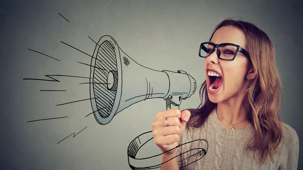 woman wearing glouses shouting through an imaginary megaphone