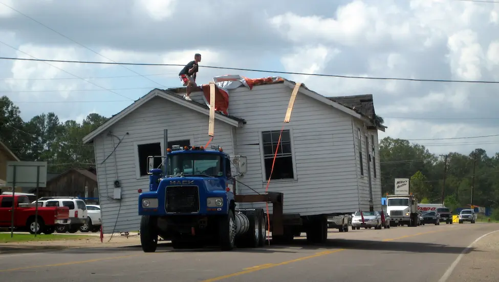 Moving a complete house on the back of a truck. 