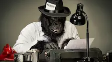 anthropomorphic journalist gorilla typing on a manual typewriter