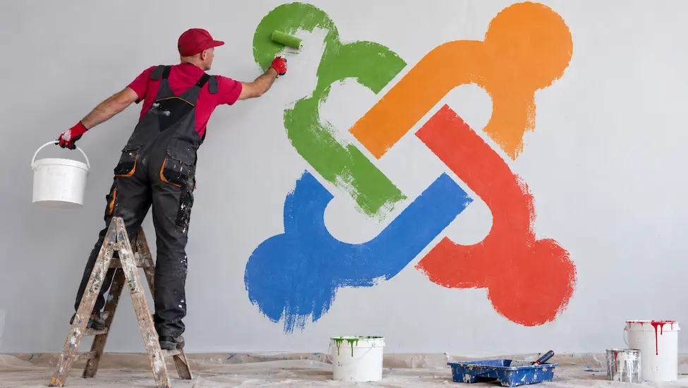 Man painting a large Joomla logo on a wall