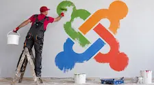 Man painting a large Joomla logo on a wall